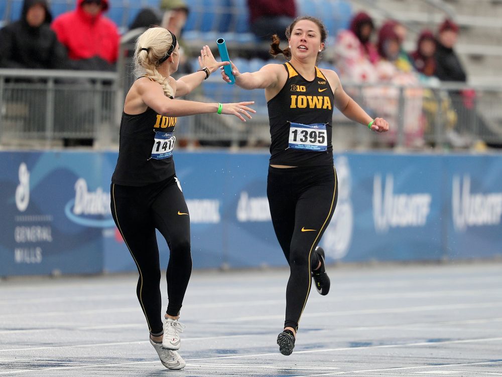 Iowa's Jenny Kimbro (right) hands the baton off to Aly Weum as they run the women's 1600 meter relay event during the third day of the Drake Relays at Drake Stadium in Des Moines on Saturday, Apr. 27, 2019. (Stephen Mally/hawkeyesports.com)