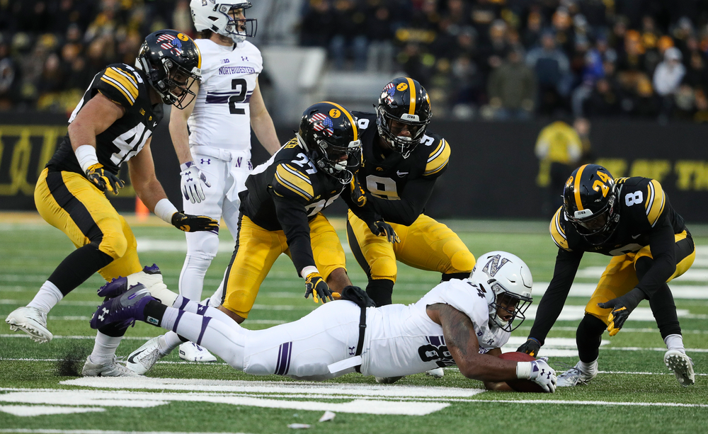 Iowa Hawkeyes linebacker Jack Hockaday (48), Iowa Hawkeyes defensive back Amani Hooker (27), Iowa Hawkeyes defensive back Geno Stone (9) and Iowa Hawkeyes defensive back Matt Hankins (8) scramble for a fumble during a game against Northwestern at Kinnick Stadium on November 10, 2018. (Tork Mason/hawkeyesports.com)