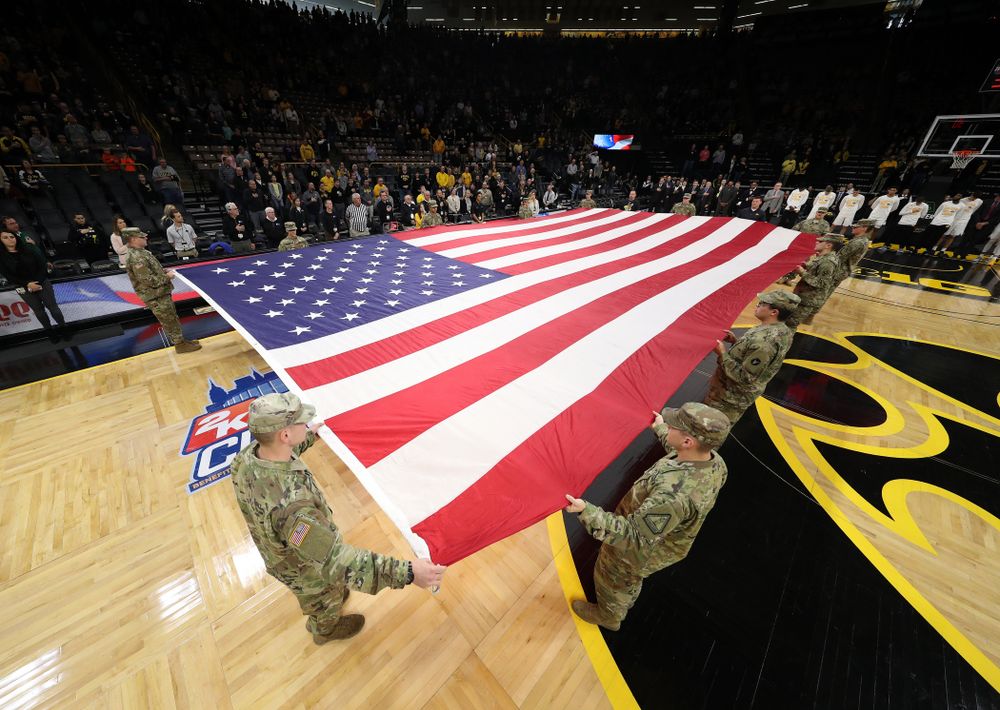 Service members stretch out a large American flag before the Iowa Hawkeyes game against UW Green Bay Sunday, November 11, 2018 at Carver-Hawkeye Arena. (Brian Ray/hawkeyesports.com)