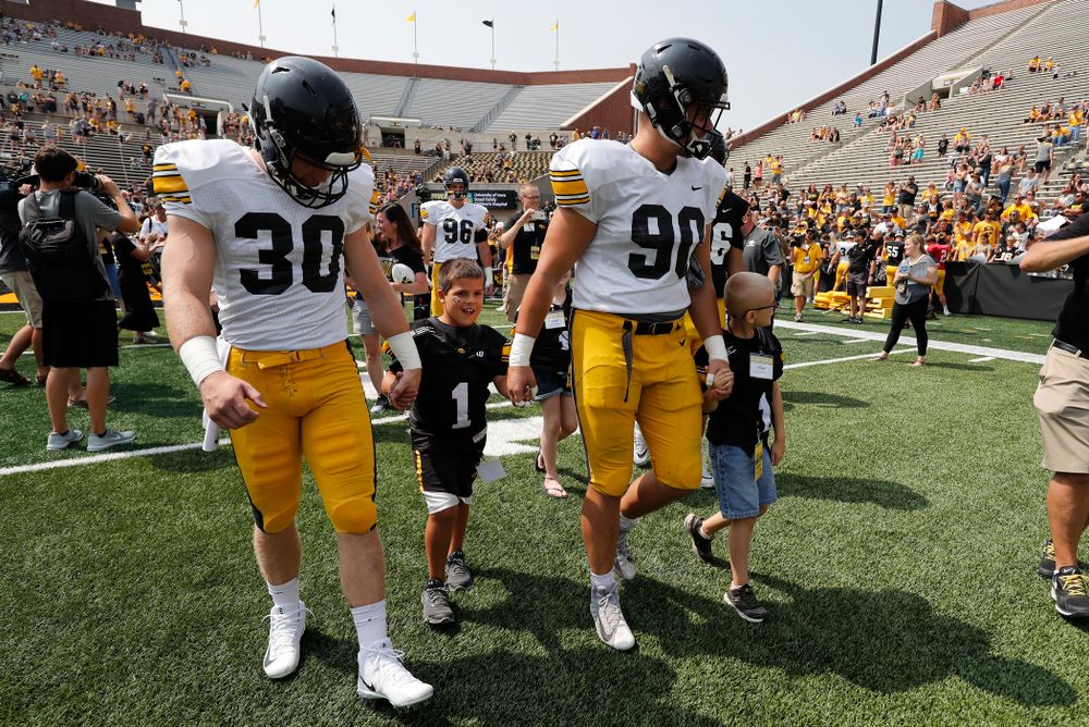 Iowa Hawkeyes defensive back Jake Gervase (30) and defensive end Sam Brincks (90) during Kids Day Saturday, August 11, 2018 at Kinnick Stadium. (Brian Ray/hawkeyesports.com)