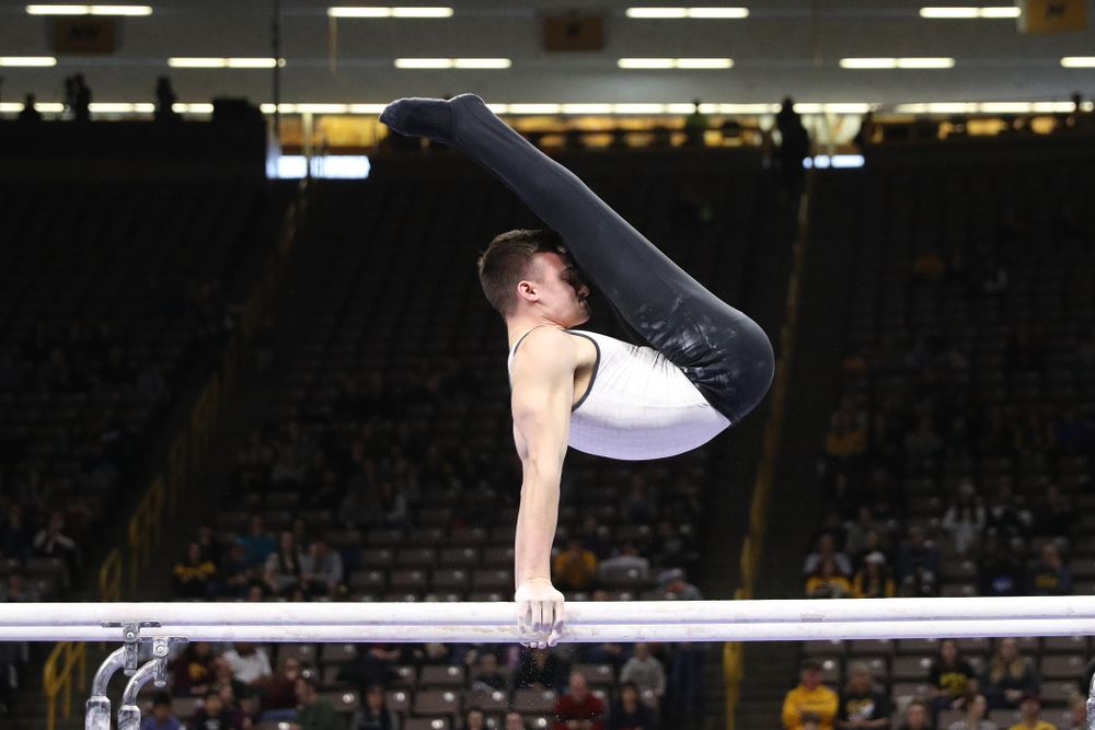 Iowa's Mitch Mandozzi competes on the parallel bars against UIC and Minnesota Saturday, February 2, 2019 at Carver-Hawkeye Arena. (Brian Ray/hawkeyesports.com)