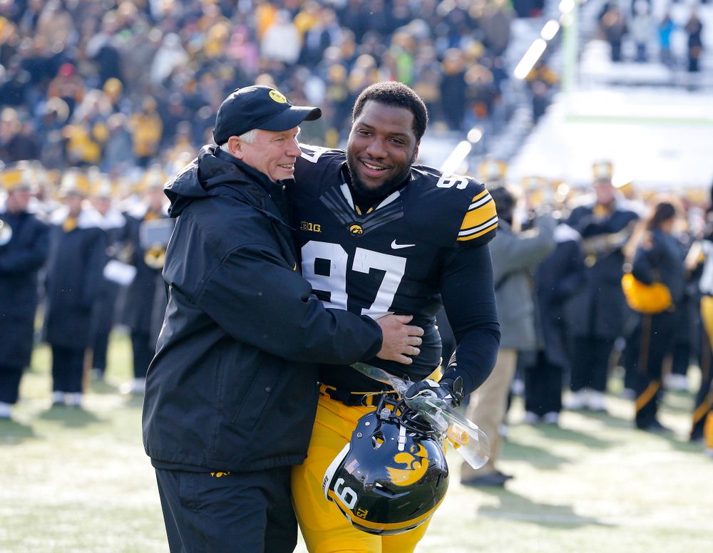 Iowa Hawkeyes defensive lineman Darian Cooper (97) hugs defensive line coach Reese Morgan during senior day activities before their game against the Purdue Boilermakers Saturday, November 21, 2015 at Kinnick Stadium. (Brian Ray/hawkeyesports.com)