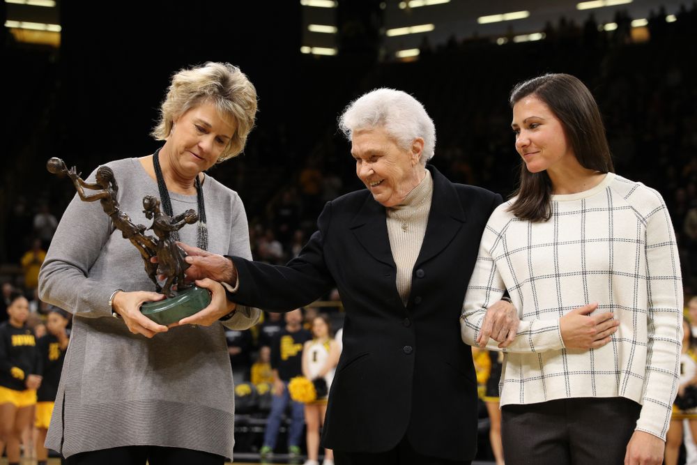 Former University of Iowa Director of Intercollegiate Athletics for Women Dr. Christine Grant receives her trophy for being inducted into the WomenÕs Basketball Hall of Fame from Iowa Hawkeyes head coach Lisa Bluder and director of basketball operations Kathryn Reynolds
before their game against the Robert Morris Colonials Sunday, December 2, 2018 at Carver-Hawkeye Arena. (Photo by Brian Ray)