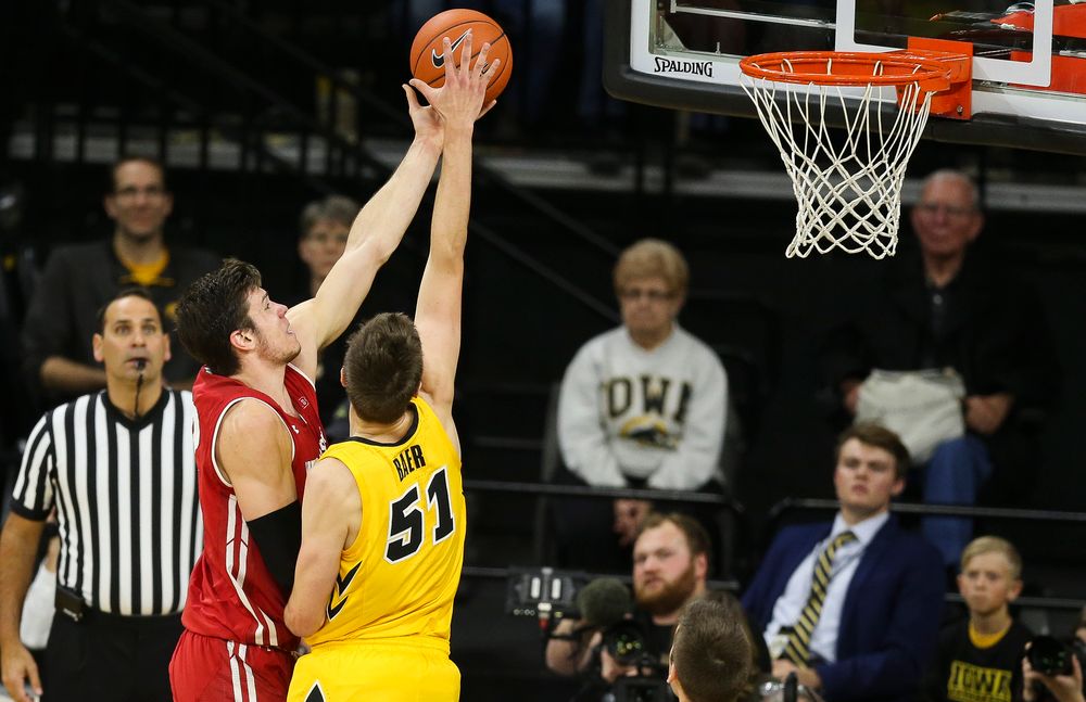 Iowa Hawkeyes forward Nicholas Baer (51) blocks a shot by Wisconsin's Ethan Happ on November 30, 2018 at Carver-Hawkeye Arena. (Tork Mason/hawkeyesports.com)