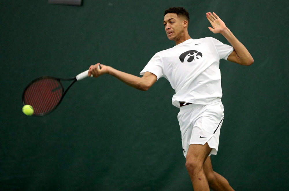 Iowa’s Oliver Okonkwo returns a shot during his singles match at the Hawkeye Tennis and Recreation Complex in Iowa City on Sunday, February 16, 2020. (Stephen Mally/hawkeyesports.com)