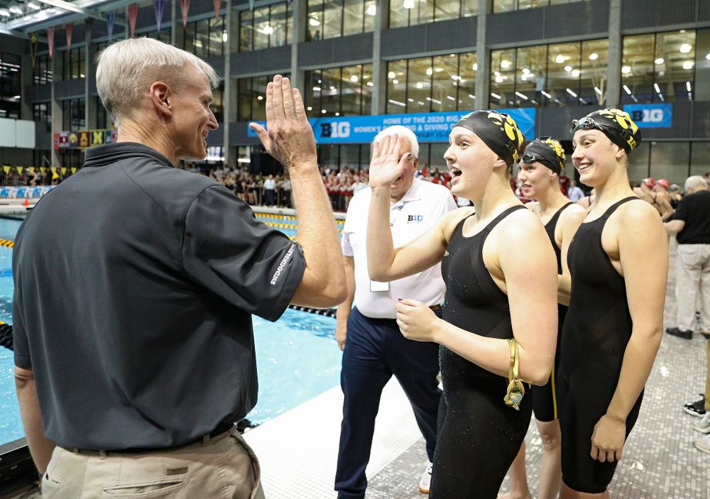 Iowa head coach Marc Long greets Hannah Burvill, Allyssa Fluit, and Emilia Sansome after they placed fourth in the 800 yard freestyle relay event during the 2020 Big Ten Women’s Swimming and Diving Championships at the Campus Recreation and Wellness Center in Iowa City on Wednesday, February 19, 2020. (Stephen Mally/hawkeyesports.com)