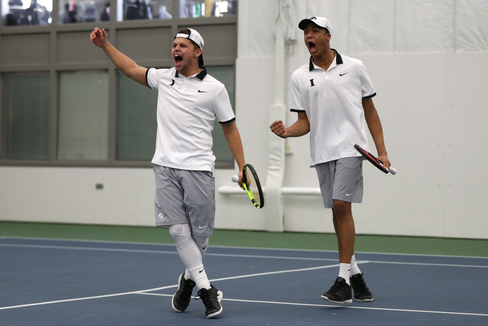Iowa's Will Davies and Oliver Okonkwo celebrate after winning a doubles match against Western Michigan Saturday, January 19, 2019 at the Hawkeye Tennis and Recreation Complex. (Brian Ray/hawkeyesports.com)