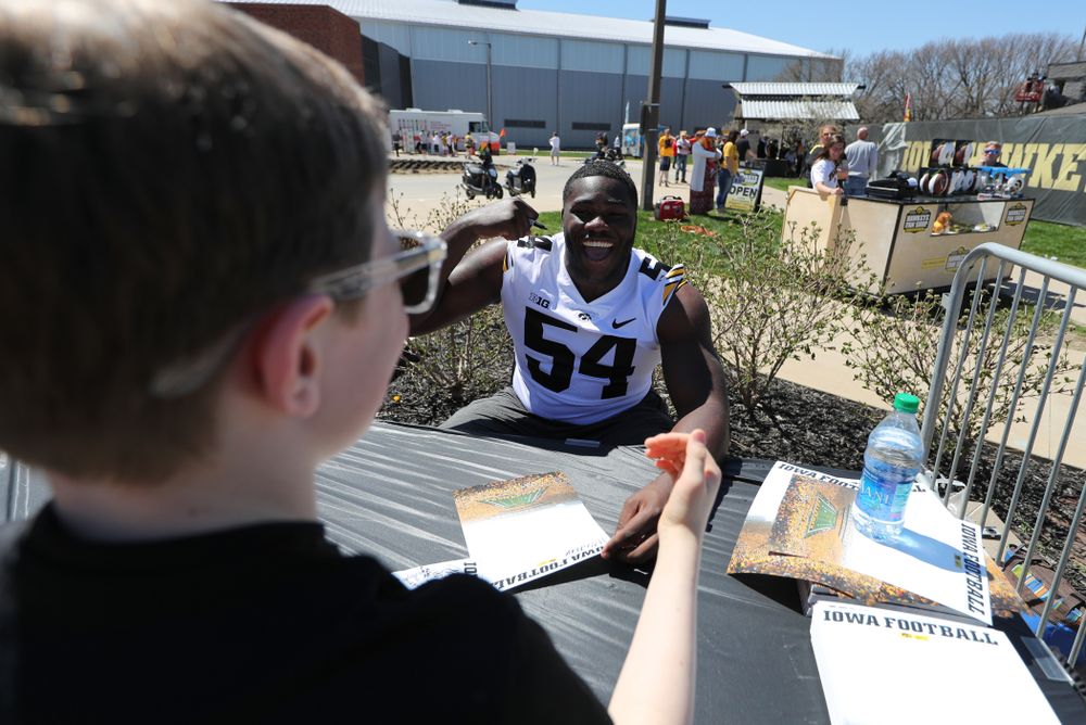Members of the Iowa Football team sign autographs before the Iowa Hawkeyes game against the Nebraska Cornhuskers Saturday, April 20, 2019 at Duane Banks Field. (Brian Ray/hawkeyesports.com)