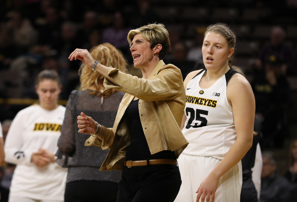 Associate head coach Jan Jensen and forward/center Monika Czinano (25) against the Illinois Fighting Illini Thursday, February 14, 2019 at Carver-Hawkeye Arena. (Brian Ray/hawkeyesports.com)