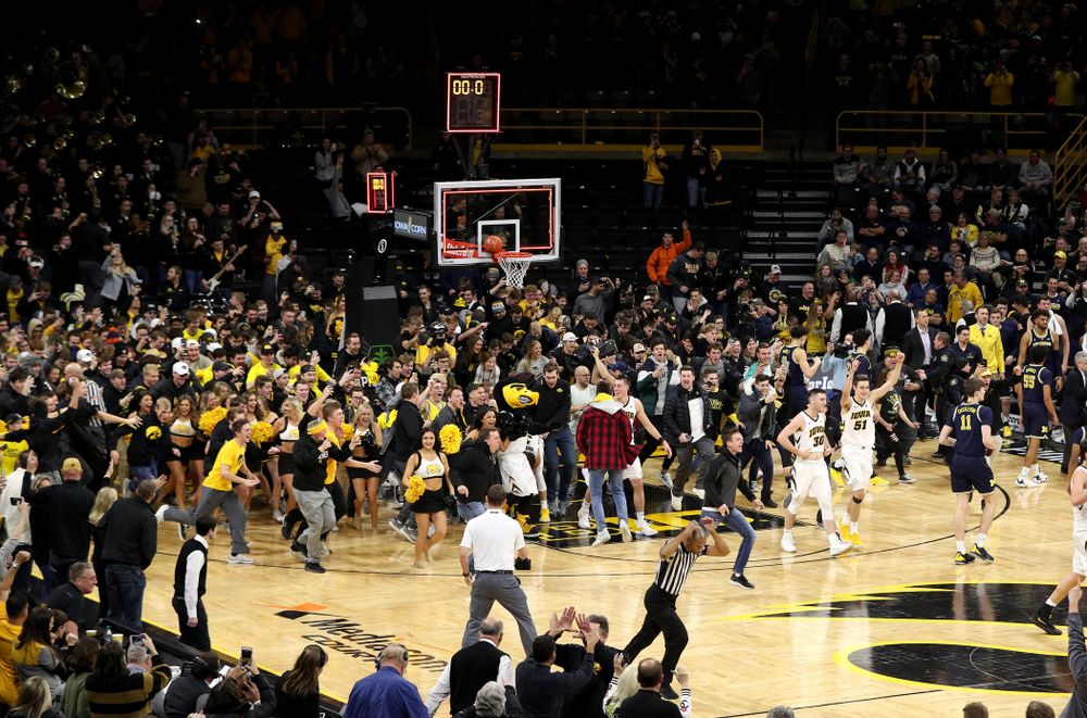 Fans storm the court after Iowa Hawkeyes defeated the Michigan Wolverines Friday, February 1, 2019 at Carver-Hawkeye Arena. (Brian Ray/hawkeyesports.com)