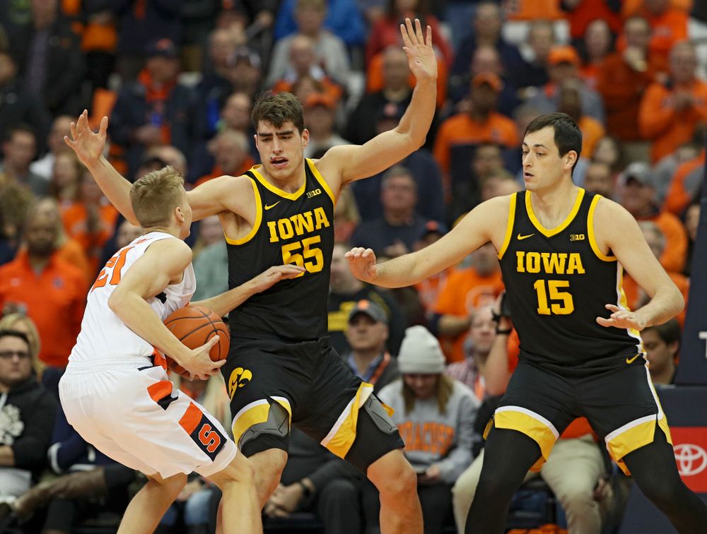 Iowa Hawkeyes center Luka Garza (55) and forward Ryan Kriener (15) pressure Syracuse Orange forward Marek Dolezaj (21) during the first half of their ACC/Big Ten Challenge game at the Carrier Dome in Syracuse, N.Y. on Tuesday, Dec 3, 2019. (Stephen Mally/hawkeyesports.com)