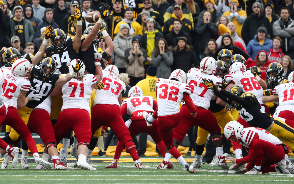 Iowa Hawkeyes defensive back Jake Gervase (30), Iowa Hawkeyes defensive end A.J. Epenesa (94) and Iowa Hawkeyes defensive end Anthony Nelson (98) try to block a field goal during a game against Nebraska at Kinnick Stadium on November 23, 2018. (Tork Mason/hawkeyesports.com)