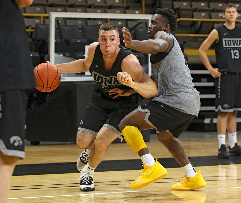 Iowa Hawkeyes guard Connor McCaffery (30) drives on guard Joe Toussaint (1) during practice at Carver-Hawkeye Arena in Iowa City on Monday, Sep 30, 2019. (Stephen Mally/hawkeyesports.com)