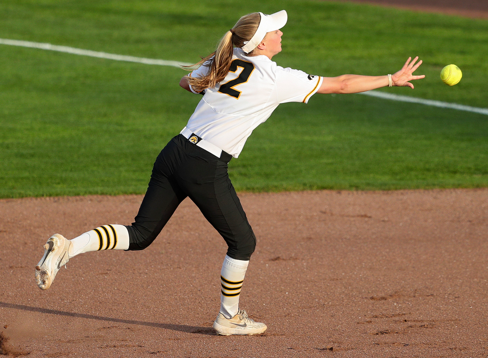 Iowa second baseman Aralee Bogar (2) tosses the ball to first base as she turns an inning ending double play during the sixth inning of their game against Ohio State at Pearl Field in Iowa City on Friday, May. 3, 2019. (Stephen Mally/hawkeyesports.com)