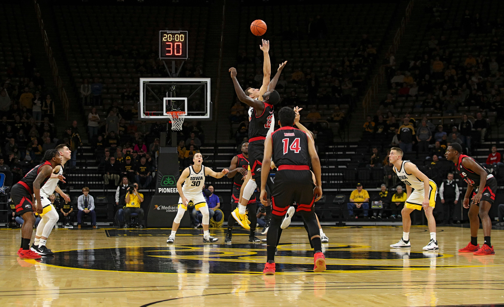 Iowa Hawkeyes forward Jack Nunge (2) jumps for the opening tip during the first half of their game at Carver-Hawkeye Arena in Iowa City on Friday, Nov 8, 2019. (Stephen Mally/hawkeyesports.com)