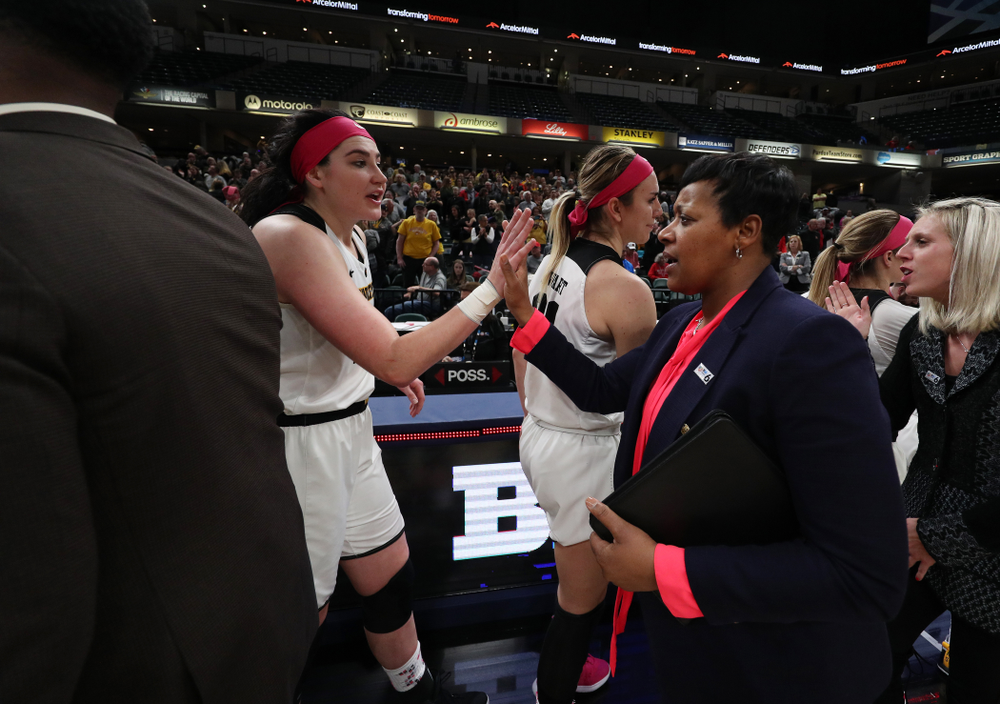 Iowa Hawkeyes forward Megan Gustafson (10) slaps hands with Rutgers Assistant Coach Michelle Edwards following their game in the semi-finals of the Big Ten Tournament Saturday, March 9, 2019 at Bankers Life Fieldhouse in Indianapolis, Ind. (Brian Ray/hawkeyesports.com)