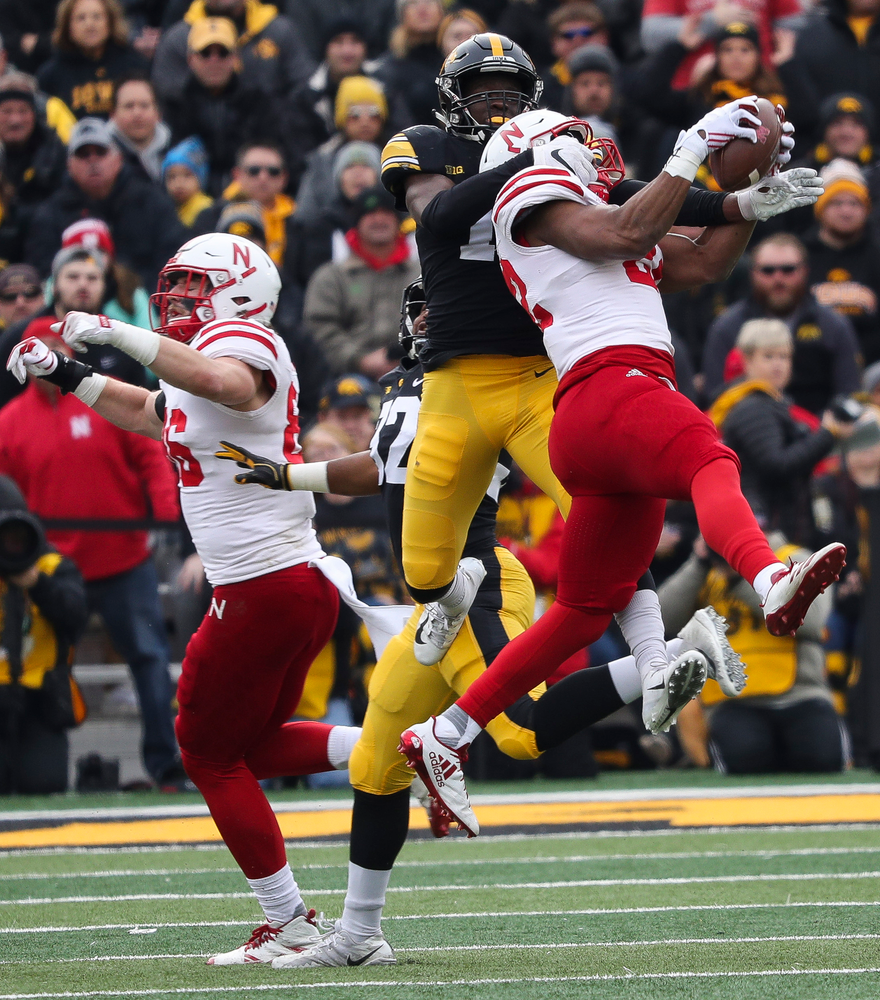 Iowa Hawkeyes defensive back Michael Ojemudia (11) breaks up a pass during a game against Nebraska at Kinnick Stadium on November 23, 2018. (Tork Mason/hawkeyesports.com)