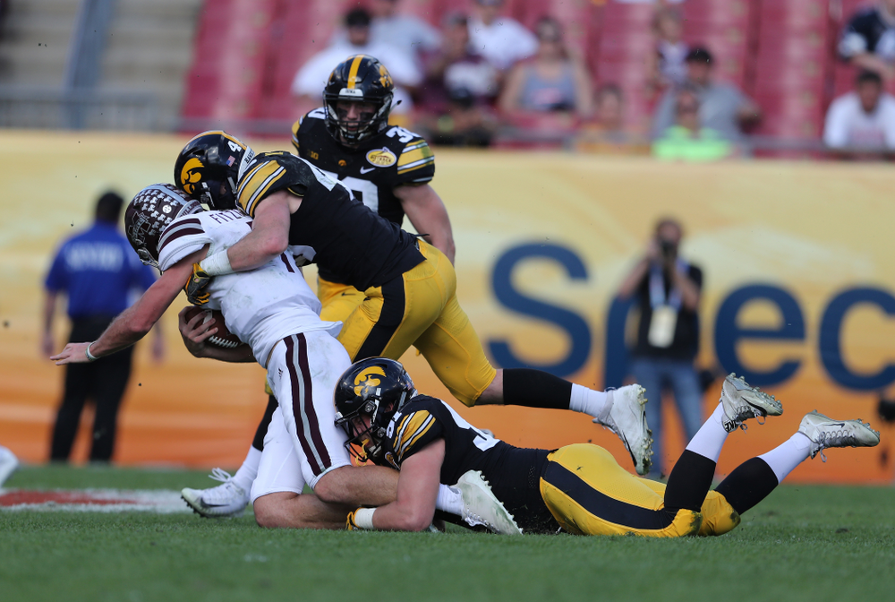 Iowa Hawkeyes defensive lineman Brady Reiff (91) and linebacker Nick Niemann (49) during the Outback Bowl Tuesday, January 1, 2019 at Raymond James Stadium in Tampa, FL. (Brian Ray/hawkeyesports.com)
