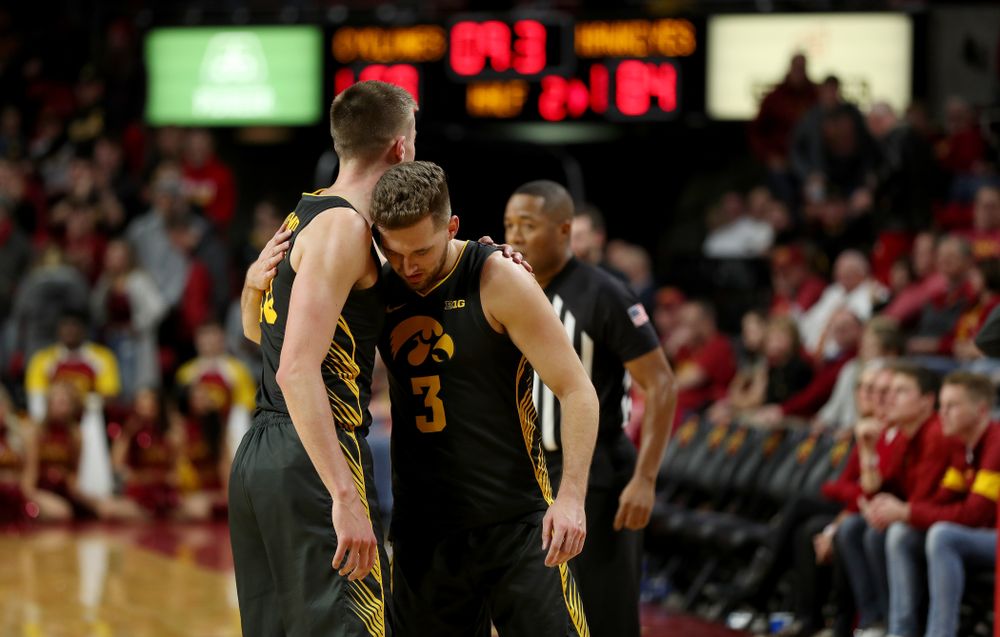 Iowa Hawkeyes guard Jordan Bohannon (3) hugs guard Joe Wieskamp (10) against the Iowa State Cyclones Thursday, December 12, 2019 at Hilton Coliseum in Ames, Iowa(Brian Ray/hawkeyesports.com)