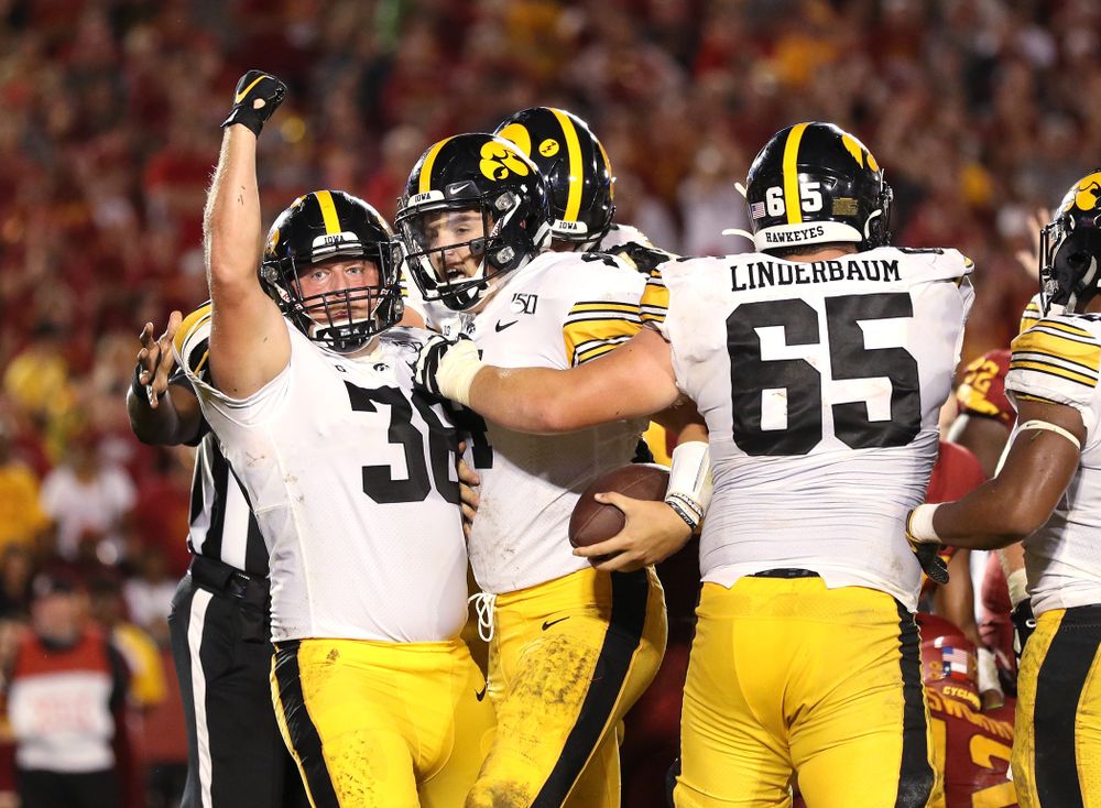 Iowa Hawkeyes quarterback Nate Stanley (4) celebrates with fullback Brady Ross (36) after scoring against the Iowa State Cyclones Saturday, September 14, 2019 in Ames, Iowa. (Brian Ray/hawkeyesports.com)