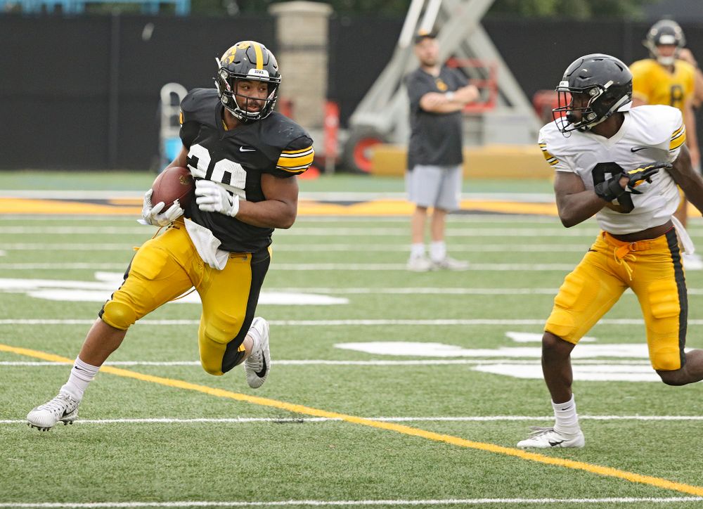 Iowa Hawkeyes running back Toren Young (28) eyes defensive back Matt Hankins (8) on a run durning Fall Camp Practice No. 17 at the Hansen Football Performance Center in Iowa City on Wednesday, Aug 21, 2019. (Stephen Mally/hawkeyesports.com)
