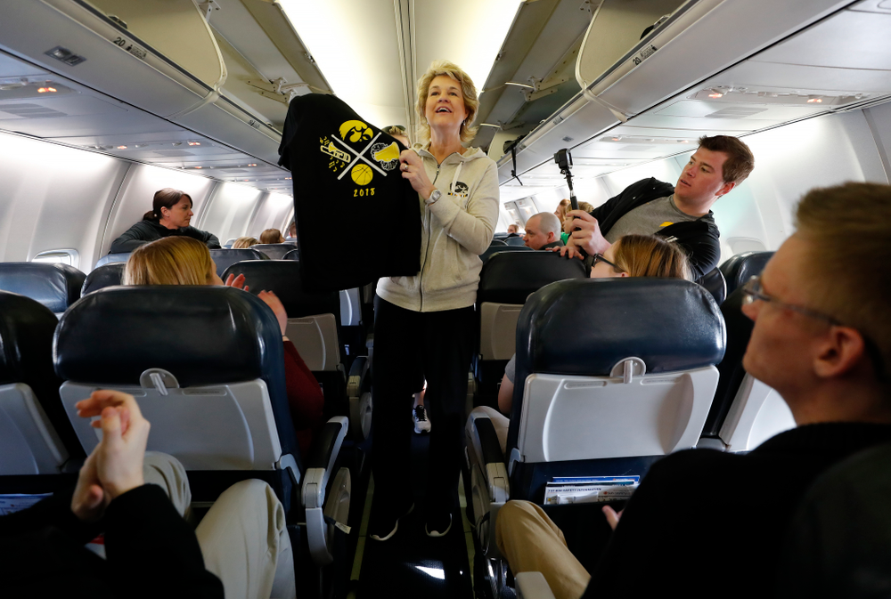Iowa Hawkeyes head coach Lisa Bluder hands out t-shirts to the pep band and spirit squad to thank them as they travel to Los Angeles for the first round of the 2018 NCAA Tournament Thursday, March 15, 2018 at the Eastern Iowa Airport. (Brian Ray/hawkeyesports.com)