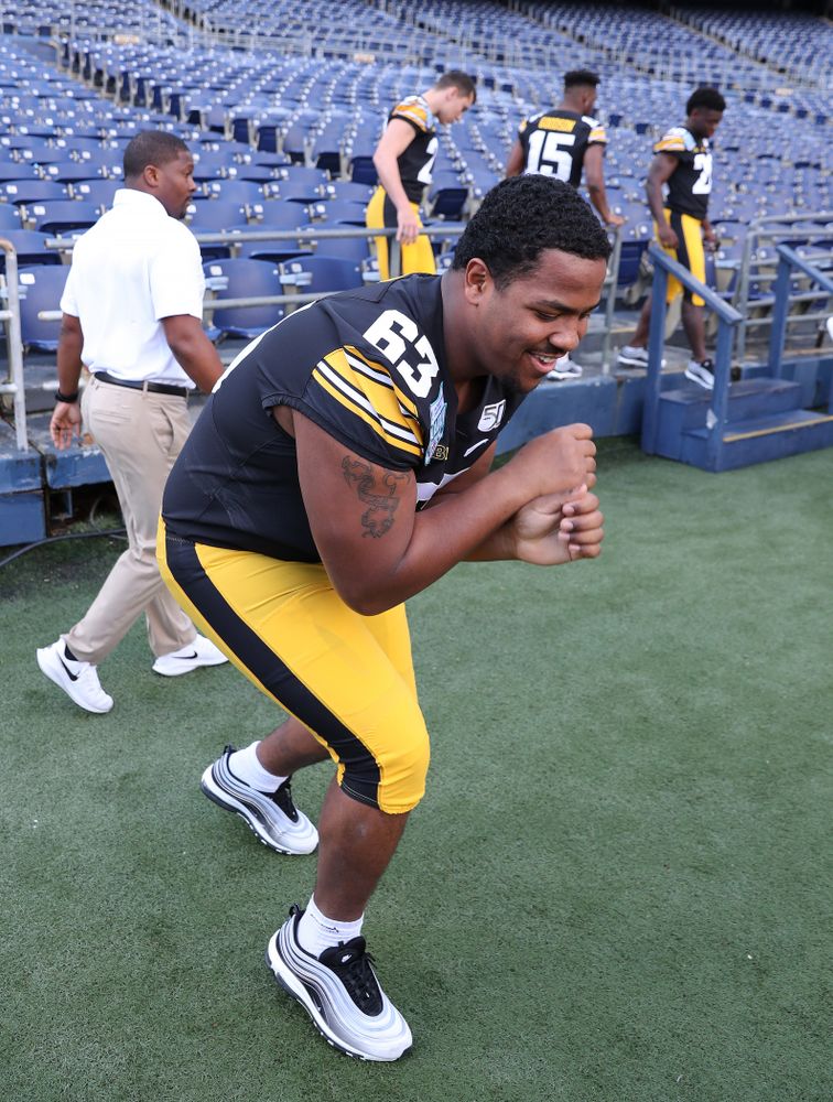 Iowa Hawkeyes offensive lineman Justin Britt (63) following the team photo Wednesday, December 25, 2019 at SDCCU Stadium in San Diego. (Brian Ray/hawkeyesports.com)