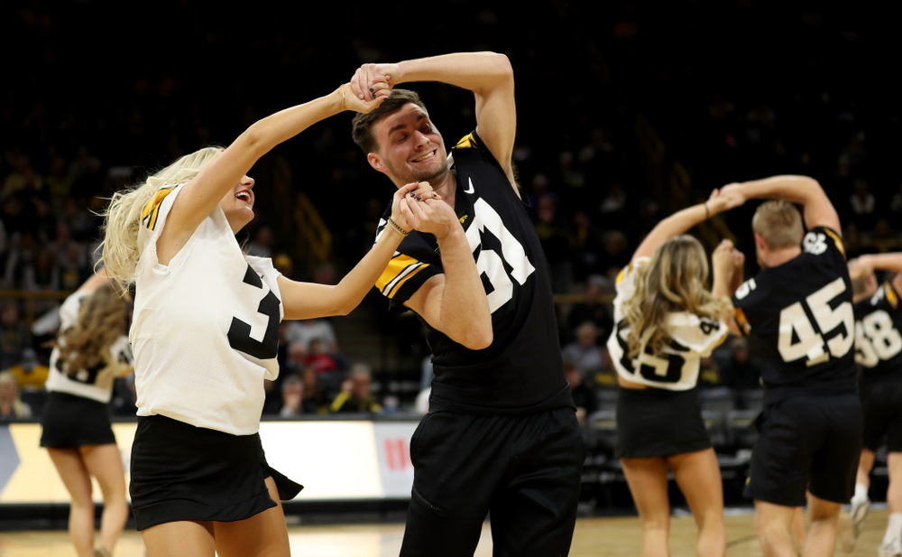 Members of the Hawkeye Football team performs with the Iowa Dance Team at halftime of the Iowa Hawkeyes game against the Ohio State Buckeyes Thursday, February 20, 2020 at Carver-Hawkeye Arena. (Brian Ray/hawkeyesports.com)