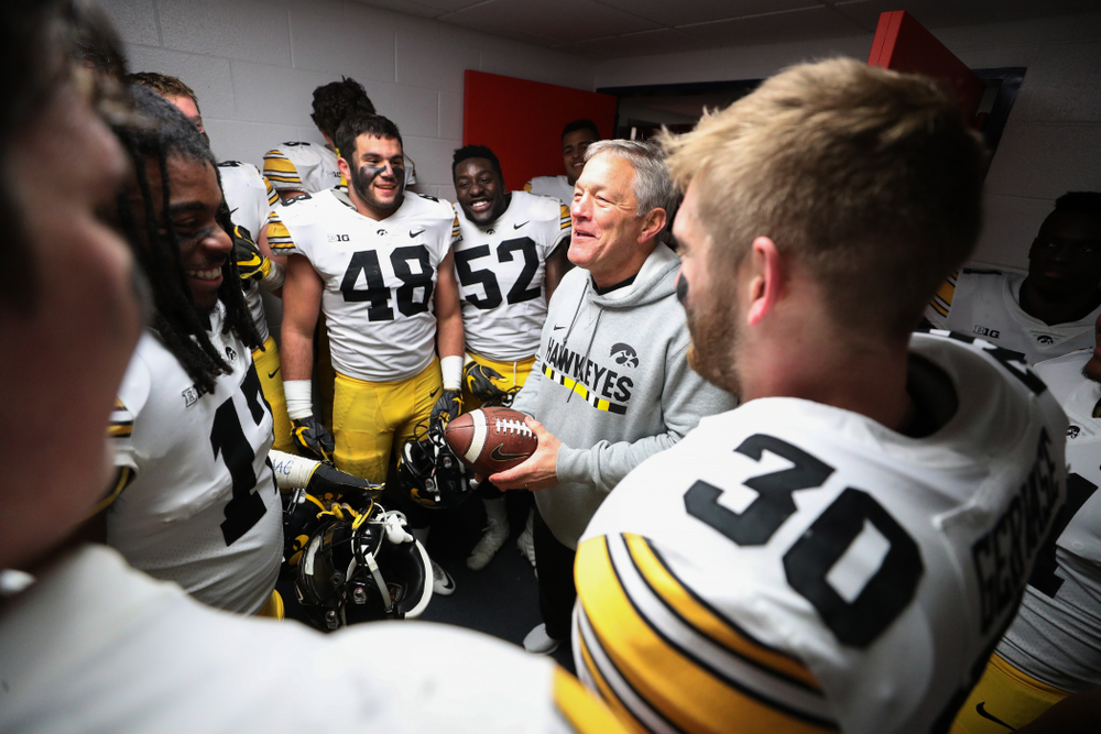 Iowa Hawkeyes defensive back Jake Gervase (30) presents the game ball to head coach Kirk Ferentz to commemorate his 150th win as head coach fo the Iowa Hawkeyes following their 63-0 win over the Illinois Fighting Illini Saturday, November 17, 2018 at Memorial Stadium in Champaign, Ill. (Brian Ray/hawkeyesports.com)