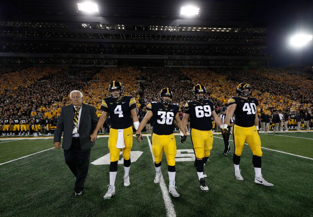 Honorary Captain Tom Moore along with captains quarterback Nate Stanley (4), fullback Brady Ross (36), offensive lineman Keegan Render (69), and defensive end Parker Hesse (40) before their game against the Wisconsin Badgers Saturday, September 22, 2018 at Kinnick Stadium. (Brian Ray/hawkeyesports.com)