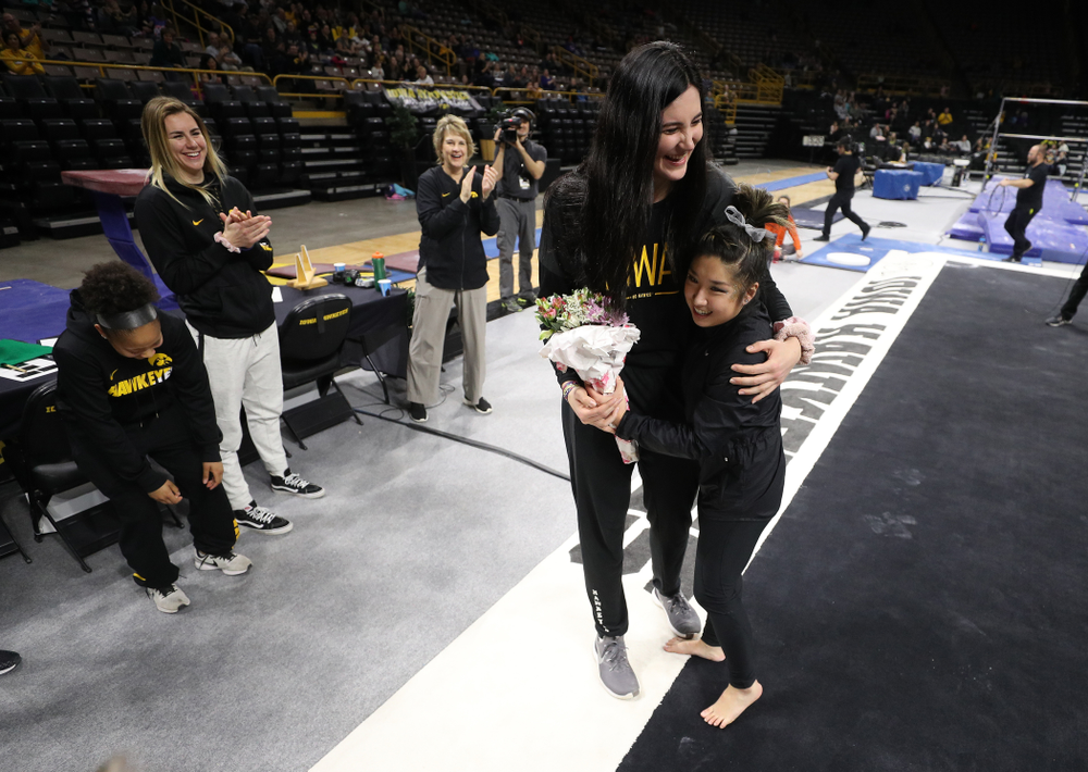 Iowa Women's Basketball seniors Megan Gustafson, Tania Davis, and forward Hannah Stewart (21) present the awards and dance the Cha Cha Slide following the Gymhawks meet against Illinois Saturday, February 16, 2019 at Carver-Hawkeye Arena. (Brian Ray/hawkeyesports.com)