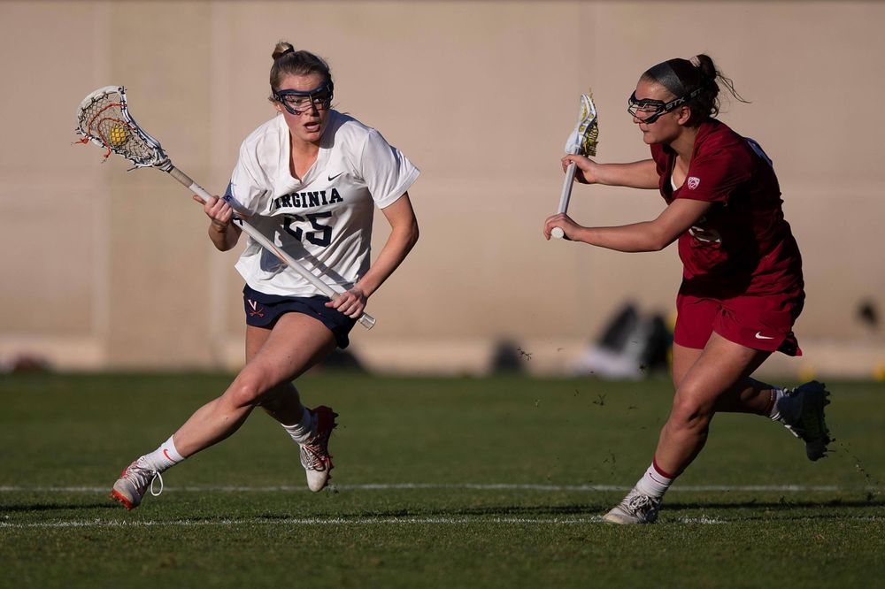 STANFORD, California - FEBRUARY 14: Virginia Cavaliers midfield Courtlynne Caskin (25) is defended by Stanford Cardinal midfield Chelsea Trattner (16) during the second half at Cagan Stadium on February 14, 2020 in Stanford, California. The Virginia Cavaliers defeated the Stanford Cardinal 12-11. (Photo by Jason O. Watson)