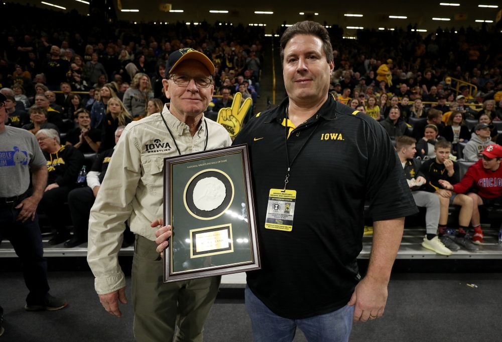 Legendary former head coach Dan Gable presents Mark Reiland with the National Wrestling Hall of Fame Lifetime Service to Wrestling Award during the Iowa Hawkeyes dual against Oklahoma State Sunday, February 23, 2020 at Carver-Hawkeye Arena. (Brian Ray/hawkeyesports.com)