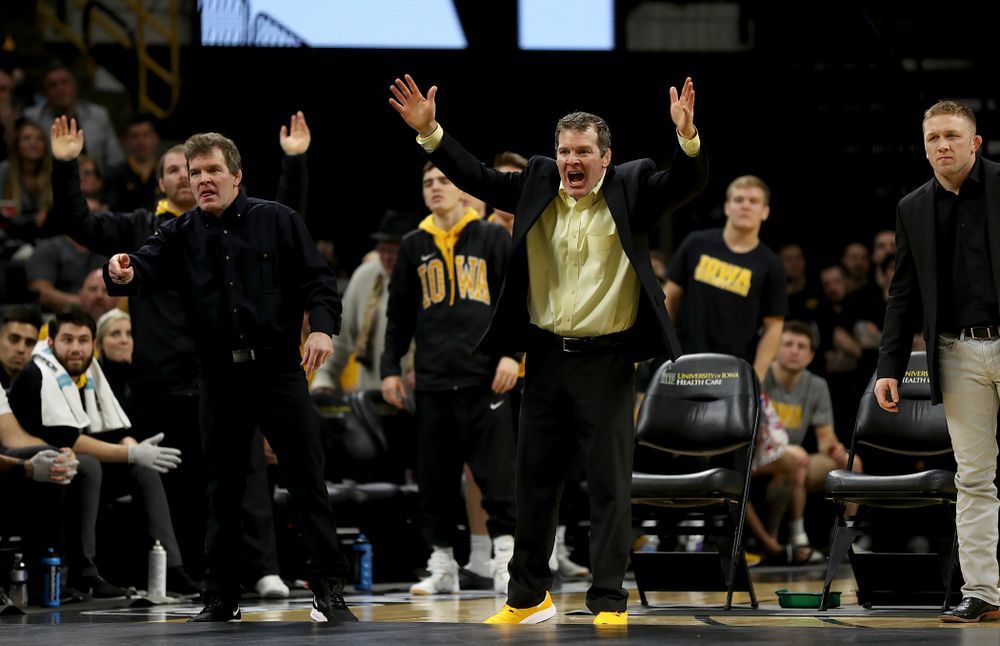 Iowa head coach Tom Brands and associate head coach Terry Brands work the sideline as Michael Kemerer wrestles Ohio State’s Kaleb Romero at 174 pounds Friday, January 24, 2020 at Carver-Hawkeye Arena. Kemerer won the match 7-1. (Brian Ray/hawkeyesports.com)