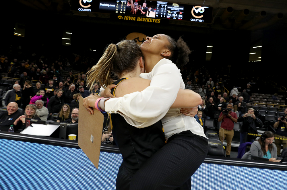 Iowa Hawkeyes forward/center Monika Czinano (25) hugs former Hawkeye and Clemson graduate assistant Tania Davis following their game Wednesday, December 4, 2019 at Carver-Hawkeye Arena. (Brian Ray/hawkeyesports.com)