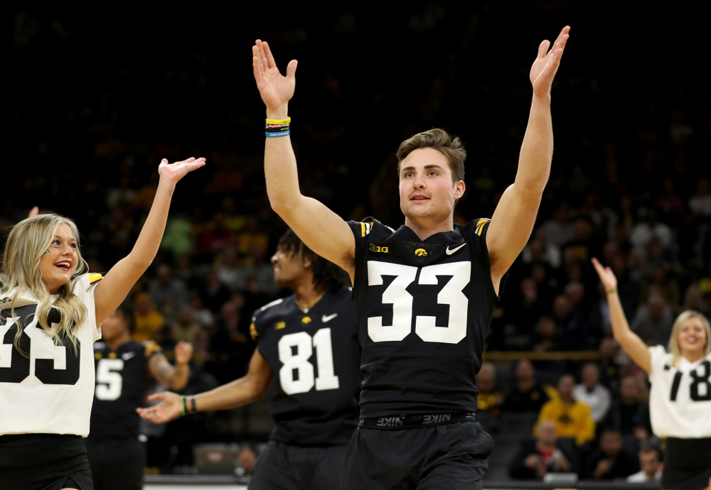 Members of the Hawkeye Football team performs with the Iowa Dance Team at halftime of the Iowa Hawkeyes game against the Ohio State Buckeyes Thursday, February 20, 2020 at Carver-Hawkeye Arena. (Brian Ray/hawkeyesports.com)