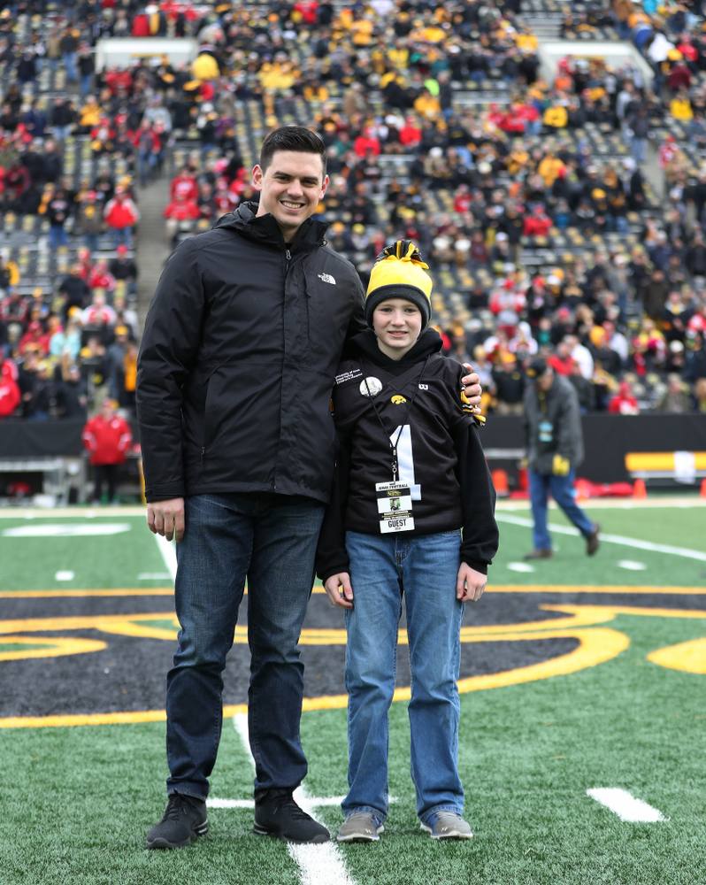 Honorary captain James Morris and Stead Family Children's Hospital Kid Captain Garret Schuster before their game against the Nebraska Cornhuskers Friday, November 23, 2018 at Kinnick Stadium. (Brian Ray/hawkeyesports.com)