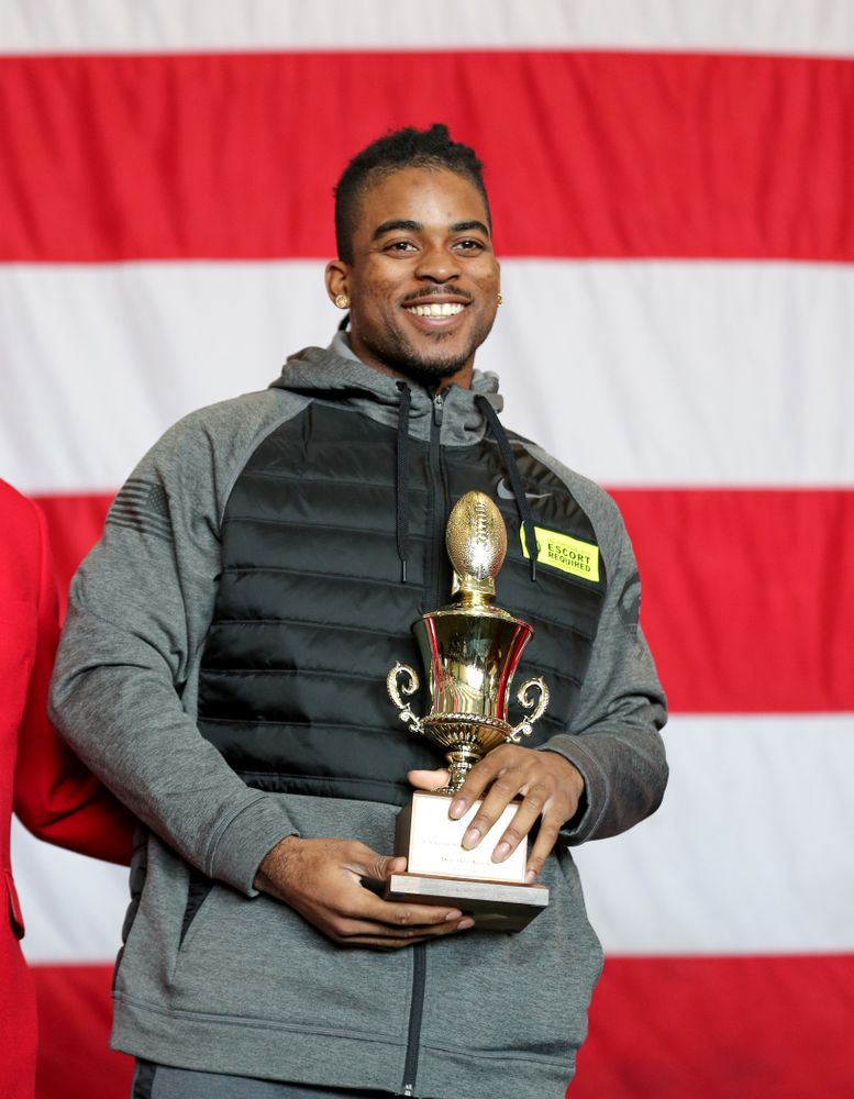 Iowa Hawkeyes defensive back Devonte Young (17) revives the U.S. Grant Sharp AdmiralÕs Trophy during tour of the USS Theodore Roosevelt (CVN-71) Tuesday, December 24, 2019 at the Naval Base Coronado. (Brian Ray/hawkeyesports.com)