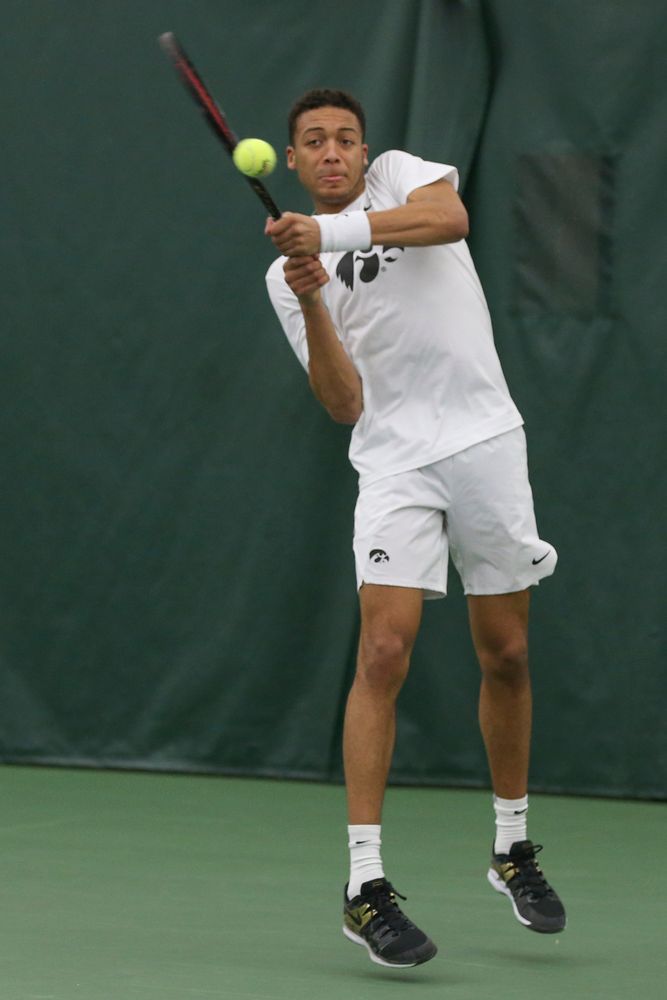 Iowa’s Oliver Okonkwo returns a hit during the Iowa men’s tennis meet vs Nebraska on Sunday, March 1, 2020 at the Hawkeye Tennis and Recreation Complex. (Lily Smith/hawkeyesports.com)