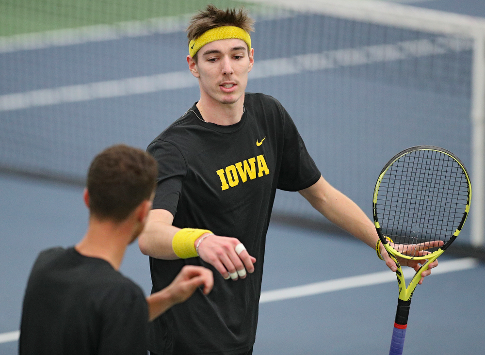 Iowa’s Nikita Snezhko (right) and Kareem Allaf celebrate a point during their doubles match against Marquette at the Hawkeye Tennis and Recreation Complex in Iowa City on Saturday, January 25, 2020. (Stephen Mally/hawkeyesports.com)