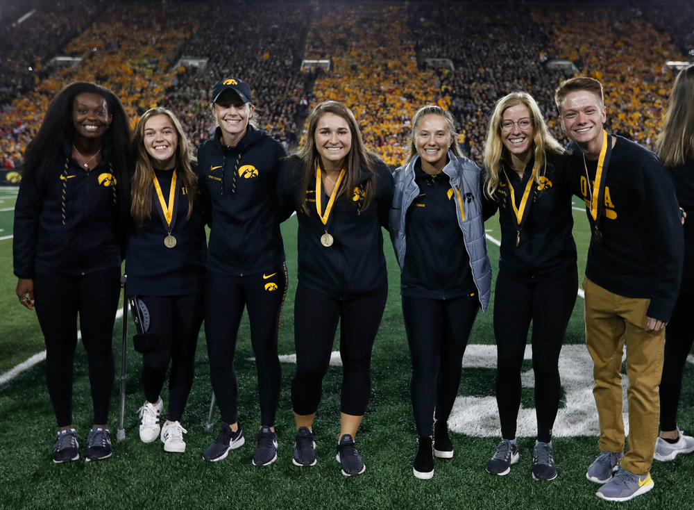 Members of the Iowa men's and women's tennis teams are recognized by the Presidential Committee on Athletics at halftime during a game against Wisconsin on September 22, 2018. (Tork Mason/hawkeyesports.com)