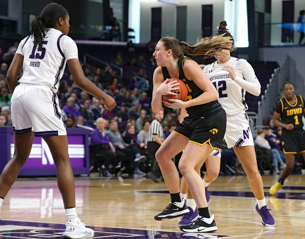 Iowa Hawkeyes forward Amanda Ollinger (43) grabs an offensive rebound during the third quarter of their game at Welsh-Ryan Arena in Evanston, Ill. on Sunday, January 5, 2020. (Stephen Mally/hawkeyesports.com)