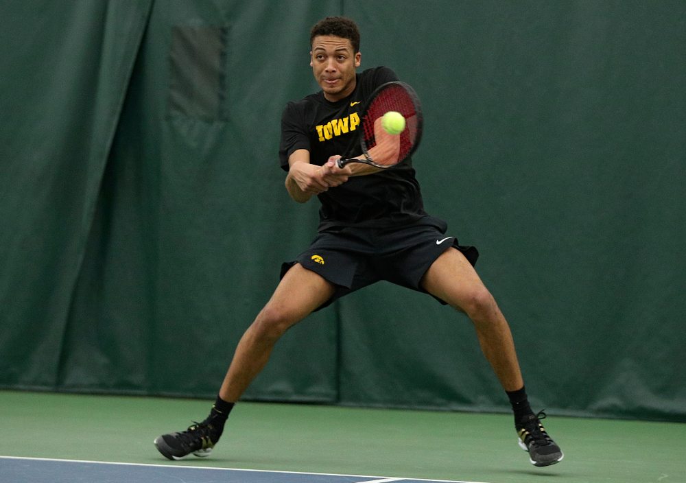 Iowa’s Oliver Okonkwo returns a shot during his singles match at the Hawkeye Tennis and Recreation Complex in Iowa City on Friday, March 6, 2020. (Stephen Mally/hawkeyesports.com)