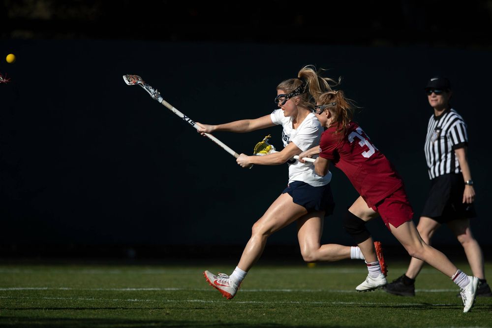STANFORD, California - FEBRUARY 14: Virginia Cavaliers midfield Courtlynne Caskin (25) scores a goal past Stanford Cardinal midfield Jacie Lemos (33) during the first half at Cagan Stadium on February 14, 2020 in Stanford, California. The Virginia Cavaliers defeated the Stanford Cardinal 12-11. (Photo by Jason O. Watson)