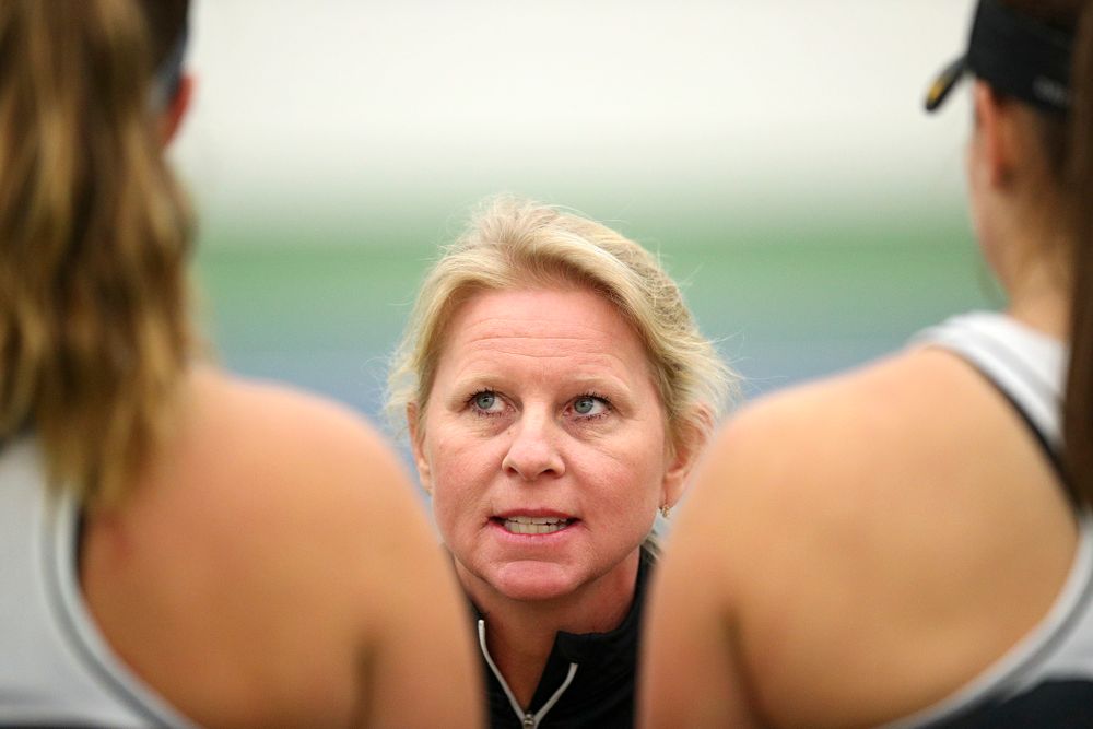 Iowa head coach Sasha Schmid (center) talks with Ashleigh Jacobs (left) and Danielle Bauers (right) during their doubles match at the Hawkeye Tennis and Recreation Complex in Iowa City on Sunday, February 16, 2020. (Stephen Mally/hawkeyesports.com)