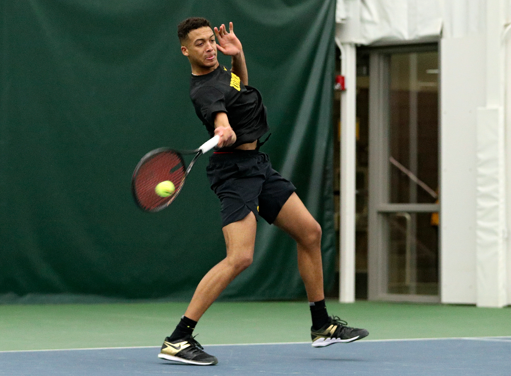 Iowa’s Oliver Okonkwo returns a shot during his singles match at the Hawkeye Tennis and Recreation Complex in Iowa City on Friday, February 14, 2020. (Stephen Mally/hawkeyesports.com)