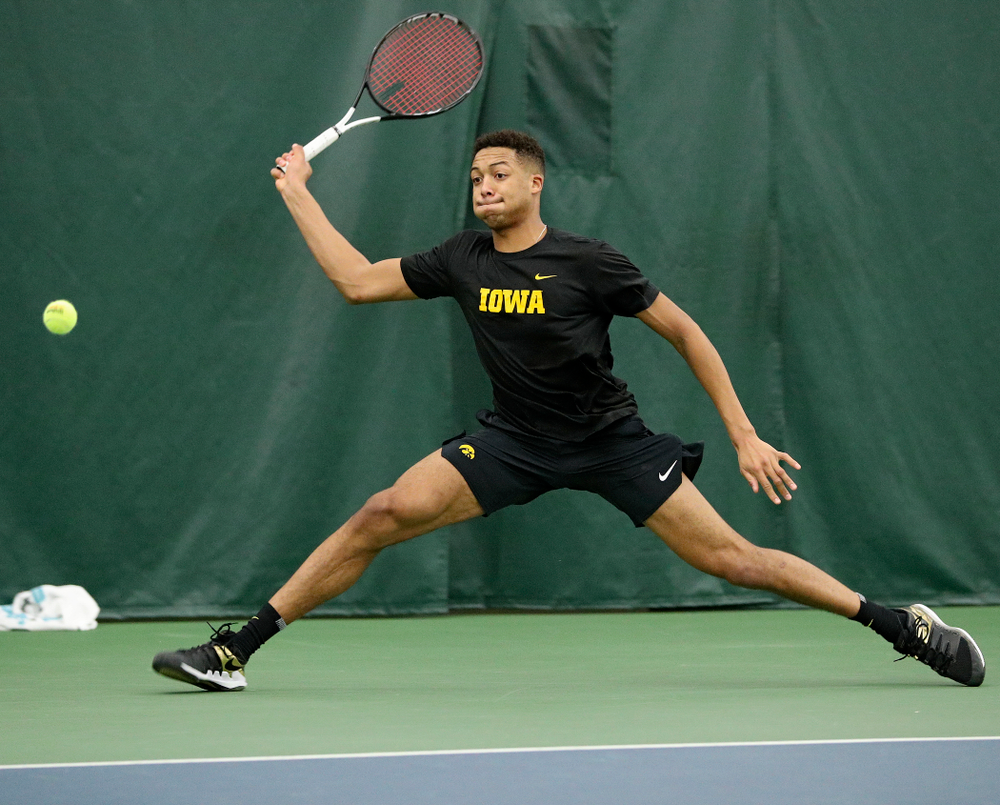 Iowa’s Oliver Okonkwo returns a shot during their match at the Hawkeye Tennis and Recreation Complex in Iowa City on Thursday, January 16, 2020. (Stephen Mally/hawkeyesports.com)