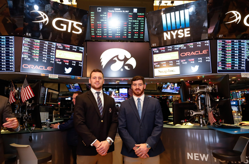 Iowa Hawkeyes linebacker Josey Jewell (43), defensive back Joshua Jackson (15), offensive lineman Sean Welsh (79) and head coach Kirk Ferentz ring the opening bell at the New York Stock Exchange Tuesday, December 26, 2017 in New York. (Brian Ray/hawkeyesports.com)