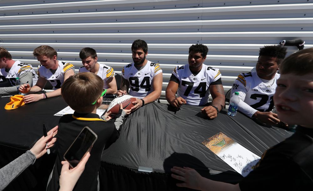 Members of the Iowa Football team sign autographs before the Iowa Hawkeyes game against the Nebraska Cornhuskers Saturday, April 20, 2019 at Duane Banks Field. (Brian Ray/hawkeyesports.com)