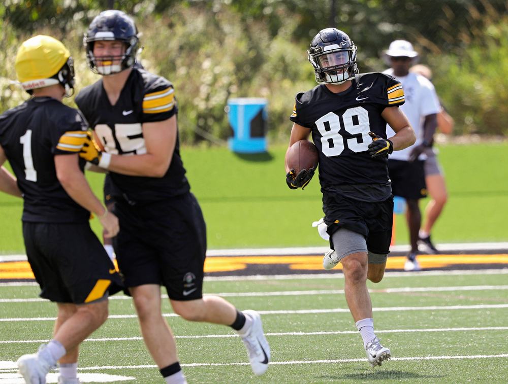 Iowa Hawkeyes wide receiver Nico Ragaini (89) smiles as he carries the ball while they work on a kick return drill during Fall Camp Practice No. 13 at the Hansen Football Performance Center in Iowa City on Friday, Aug 16, 2019. (Stephen Mally/hawkeyesports.com)